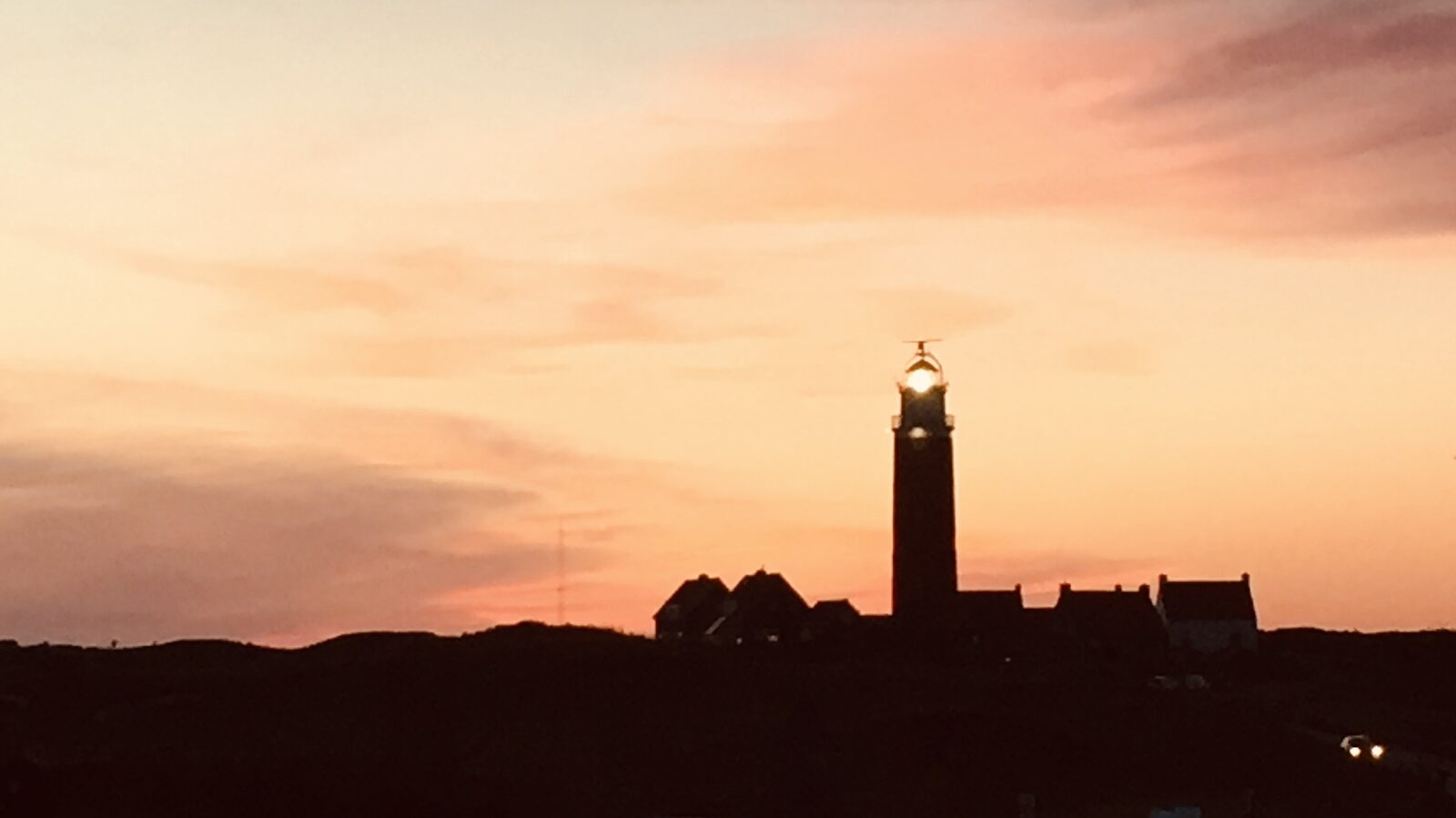 De vuurtoren van Texel als silhouet bij zonsondergang.